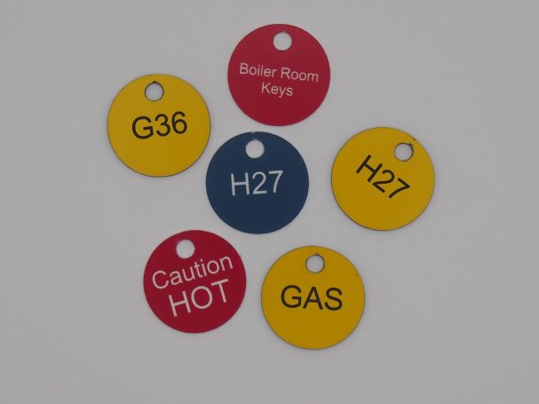 Various coloured identification tags, including red and yellow, with labels for keys and warnings.